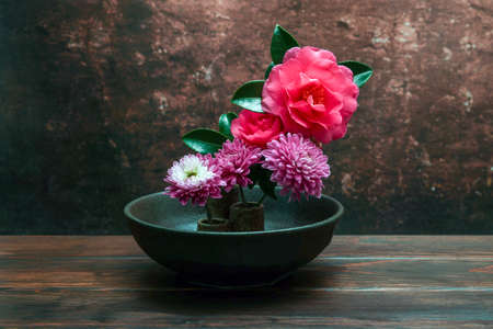 sasanqua and chrysanthemums are arranged in japanese style