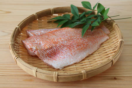 fillet of raw fish on the bamboo colander