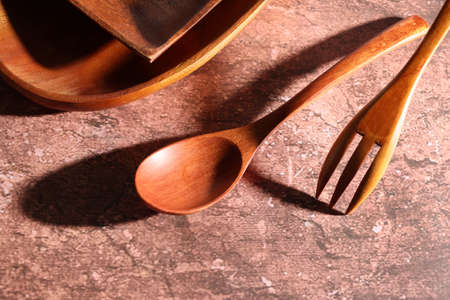 wooden tableware in the marble pattern backgroundの写真素材