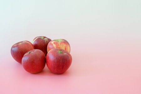 apples in a pink backgroundの写真素材