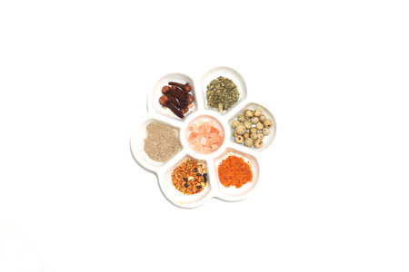 various kind of seasoning in the flower shaped white plate