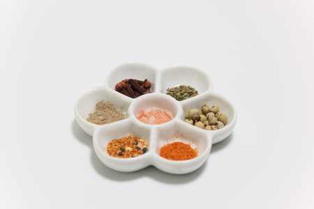 various kind of seasoning in the flower shaped white plateの写真素材