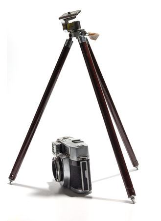 old camera and tripod in a white backgroundの写真素材