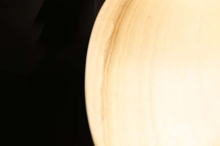 Close-up picture of onyx vase in a black background.