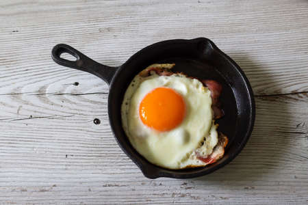bacon and egg on the frying panの写真素材