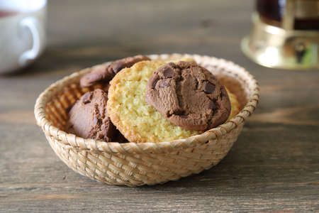 cookies in the basket on the wooden tableの写真素材