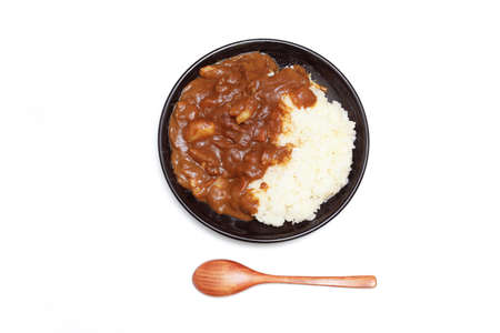 Curry and rice on the black dish isolated on a white background.の写真素材