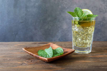 Iced mint tea in the glass on the wooden table.の写真素材