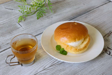 bread with fresh whipped cream on the white dish.の写真素材