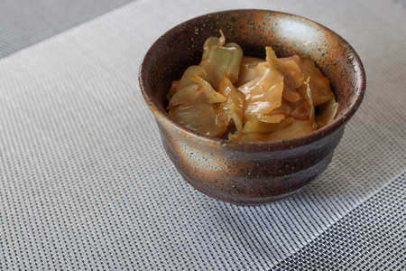 Pickled sichuan vegetable in a bowl on the place mat.の写真素材