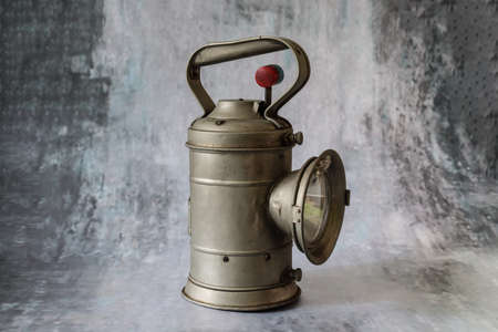 old railroad signal light in a concrete pattern backgroundの写真素材