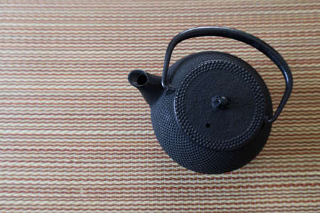 Japanese iron teapot and tea on the tatami mat.