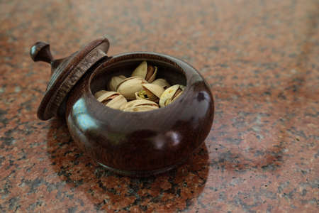 Pistachio in the bowl on the marble plate.