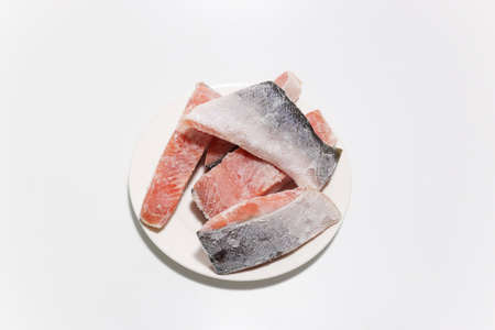 frozen salmon fillets in a white background