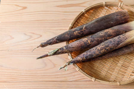 bamboo shoot with sheath on the bamboo colanderの写真素材