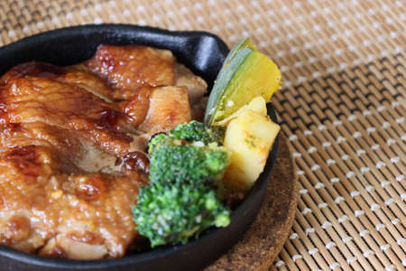 chicken steak on the frying pan.