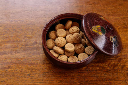 Japanese cookies in the vessel on the wooden table.の写真素材