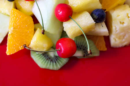 small pieces of fruit isolated on a red background.の写真素材