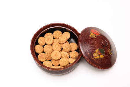 Japanese cookies in the vessel isolated on a white background.の写真素材