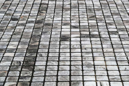 Marble-patterned tiled sidewalk fills in whole screen.の写真素材
