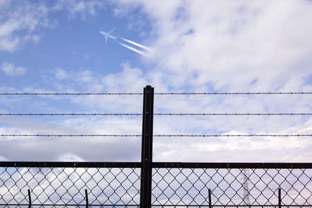 Barbed wire entanglement taken against a blue sky background.の写真素材