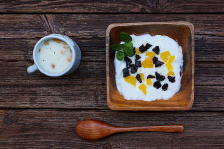 Yogurt with soup in the cup on the wooden table.の写真素材