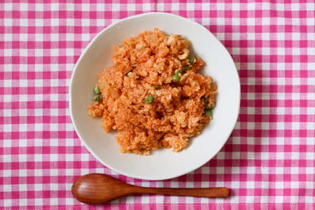 Chicken rice on the dish isolated on the gingham check tablecloth.の写真素材