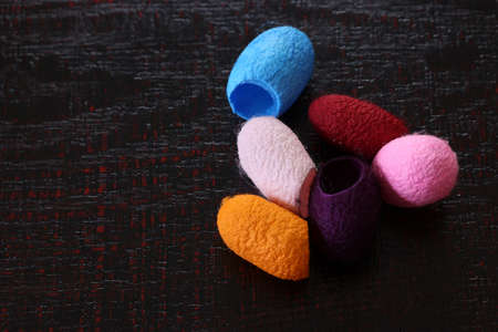 Colored cocoons and beanbag on a ilacquerware board.の写真素材