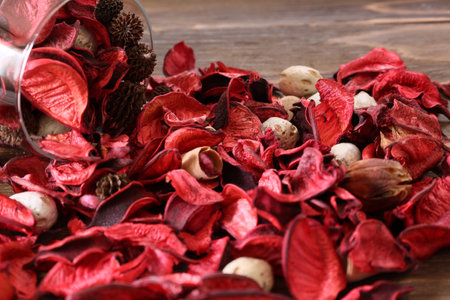 Potpourri in a glass isolated on a wooden table.の写真素材