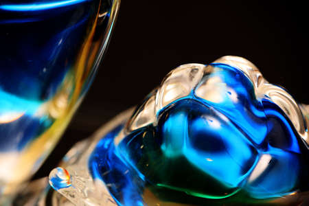Close-up picture of glass figurine isolated in a black background.の写真素材