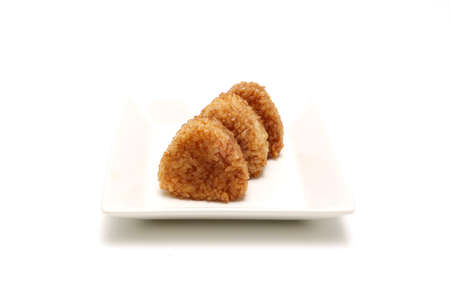 Grilled rice balls on a plate isolated on a white background.