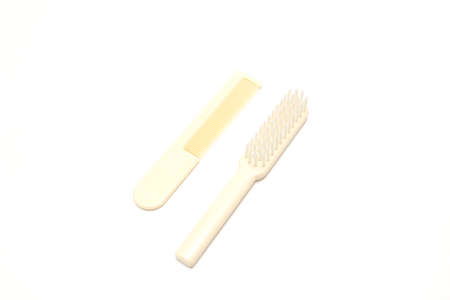 Comb and hairbrush isolated on a white background.