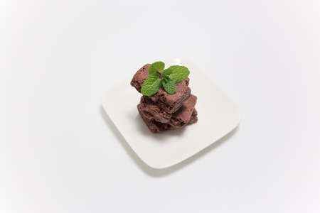 Leftover pieces of chocolate cake in a white background.の写真素材