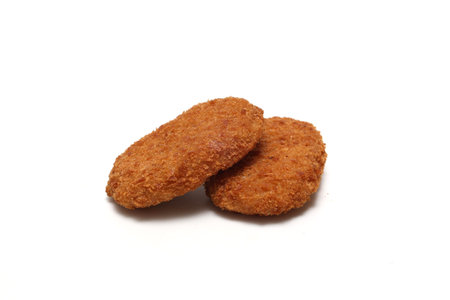 Deep fried mashed potatoes covered with bread crumbs isolated on a white background.