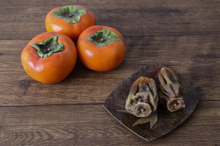 Persimmons dried persimmon on the wooden table.の写真素材