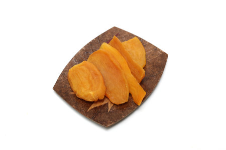 Dried sweet potato on a plate isolated on a white background.の写真素材