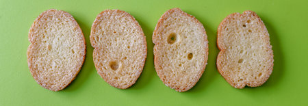 Clipped to banner size image of rusks isolaed on a green background.