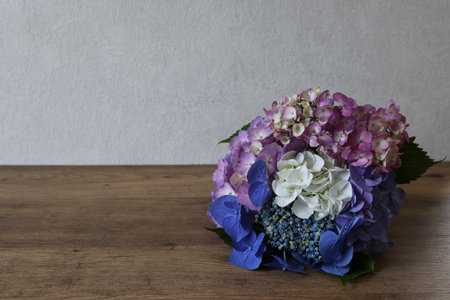 Bouquet of hydrangea flowers on a wooden tableの写真素材