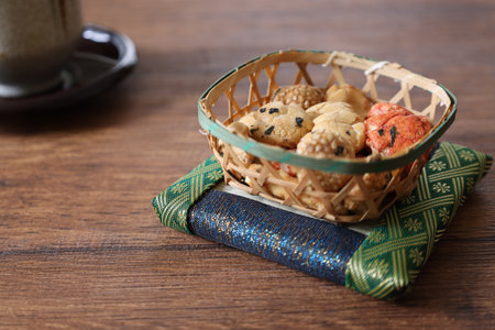 Bean snacks in a bamboo colander on a wooden table.