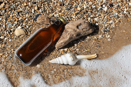 Bottled beer on the sand by the sea.の写真素材