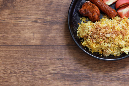 Biryani on the black dish on the wooden table.の写真素材