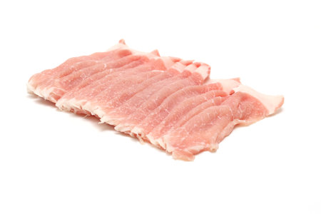 Thinly sliced raw pork isolated on a white background.