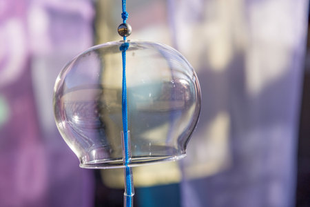 Close-up picture of glass wind chimes taken outdoors.