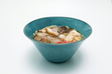 Okinawan style noodle soup with pork isolated on a white background.の写真素材