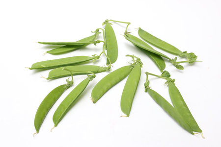 Fresh green peas isolated on white background. Pea pods close up.の写真素材