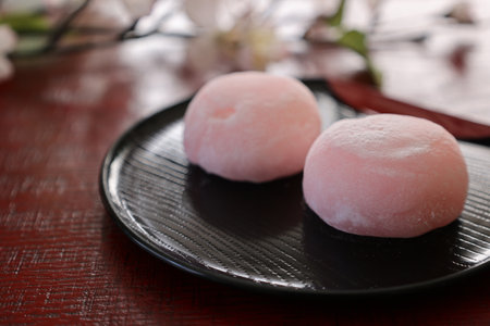 Soft round rice cake stuffed with sweet bean jam in a glass bowlの写真素材