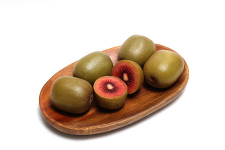 RedãKiwi fruits on a wooden plate isolated on a white background.の写真素材