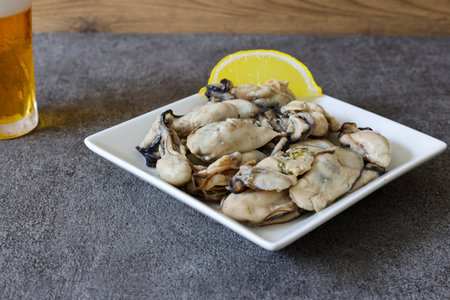 Fresh oysters with lemon and beer on the table. Seafoodの写真素材