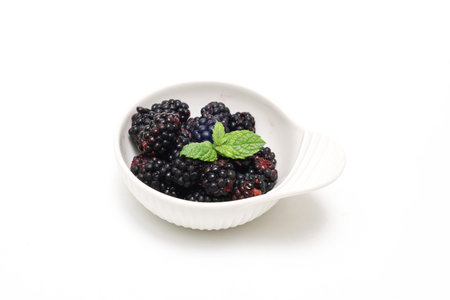 Blackberry and mint in a bowl on a white background. Isolated