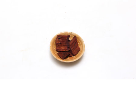 Sandalwoods on a platel isolated on a white background.